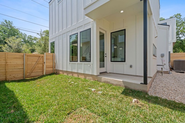 52 Robert T Martinez Jr St, Austin, TX 78702 - rear view of property featuring board and batten siding and central AC