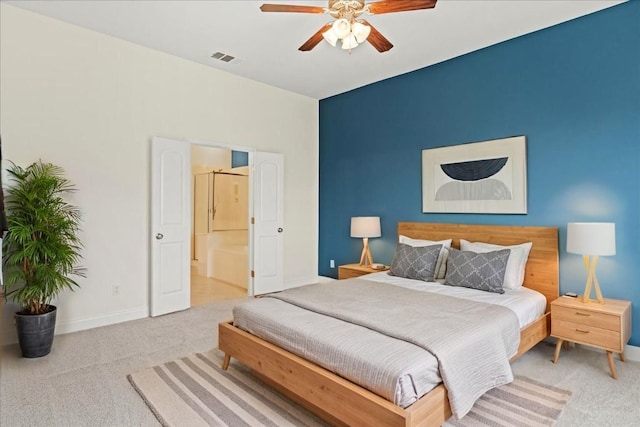 2210 Onion Creek Pkwy Unit 604, Austin, TX 78747 - carpeted bedroom featuring baseboards, ensuite bath, and a ceiling fan