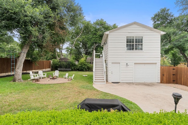 1711 Mohle Dr, Austin, TX 78703 - view of yard featuring stairs, an outdoor fire pit, driveway, and an attached garage