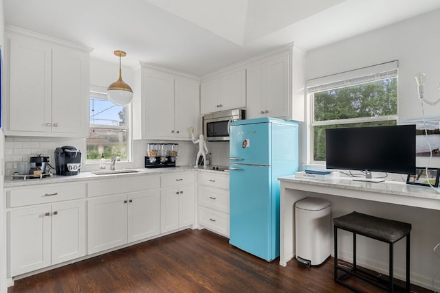 1711 Mohle Dr, Austin, TX 78703 - kitchen with freestanding refrigerator, stainless steel microwave, a sink, decorative backsplash, and plenty of natural light