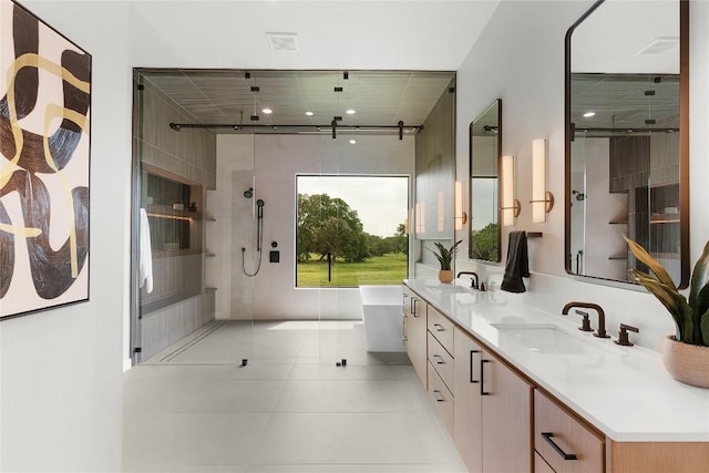 8341 Brewer Ln, Salado, TX 76571 - bathroom with a stall shower, double vanity, a soaking tub, and tile patterned floors