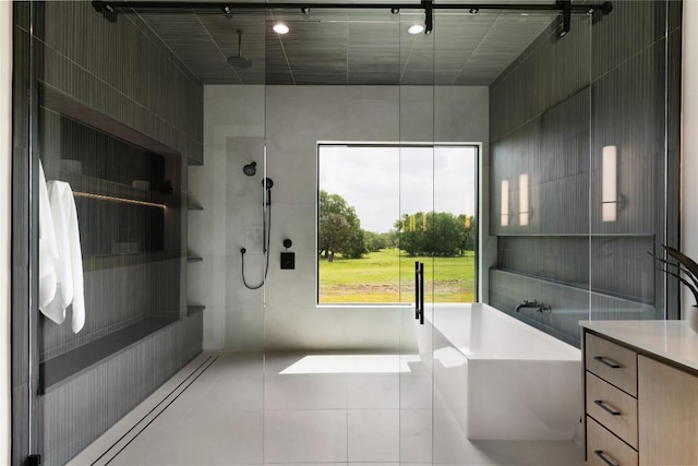 8341 Brewer Ln, Salado, TX 76571 - bathroom with a stall shower, a freestanding bath, and tile patterned flooring