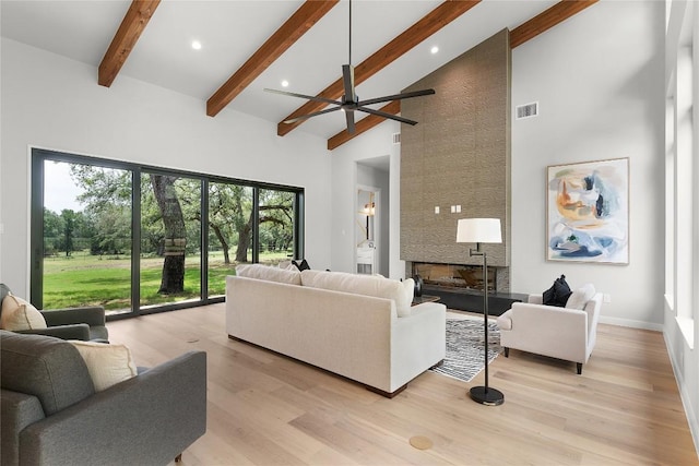 8341 Brewer Ln, Salado, TX 76571 - living room with high vaulted ceiling, a fireplace, beam ceiling, ceiling fan, and light wood-style floors