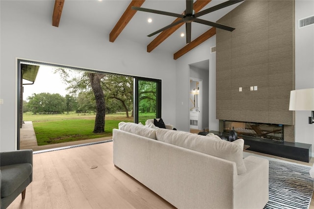 8341 Brewer Ln, Salado, TX 76571 - living area featuring beamed ceiling, high vaulted ceiling, ceiling fan, wood finished floors, and recessed lighting