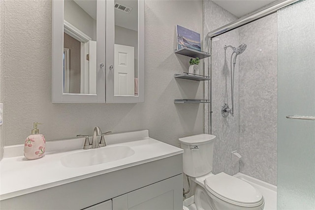 8002 Magic Mountain Cv, Round Rock, TX 78681 - bathroom featuring a textured wall, a shower with door, and vanity