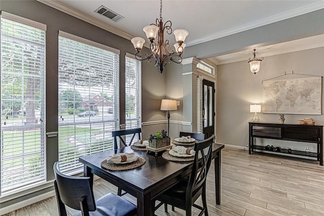8002 Magic Mountain Cv, Round Rock, TX 78681 - dining space with a chandelier, plenty of natural light, light wood-style floors, and crown molding