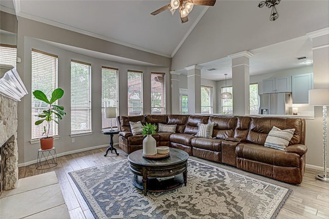 8002 Magic Mountain Cv, Round Rock, TX 78681 - living room featuring a ceiling fan, decorative columns, plenty of natural light, crown molding, and light wood-type flooring