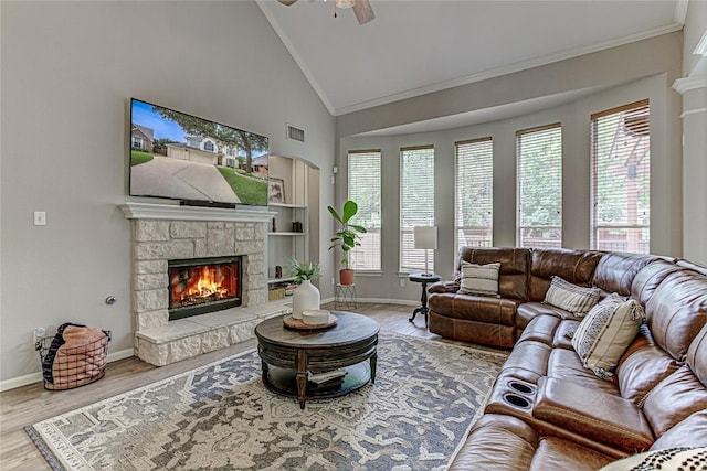 8002 Magic Mountain Cv, Round Rock, TX 78681 - living room with ceiling fan, crown molding, a fireplace, healthy amount of natural light, and wood finished floors