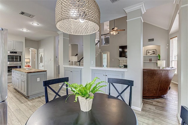 8002 Magic Mountain Cv, Round Rock, TX 78681 - dining space with a ceiling fan, ornate columns, light wood-type flooring, and high vaulted ceiling