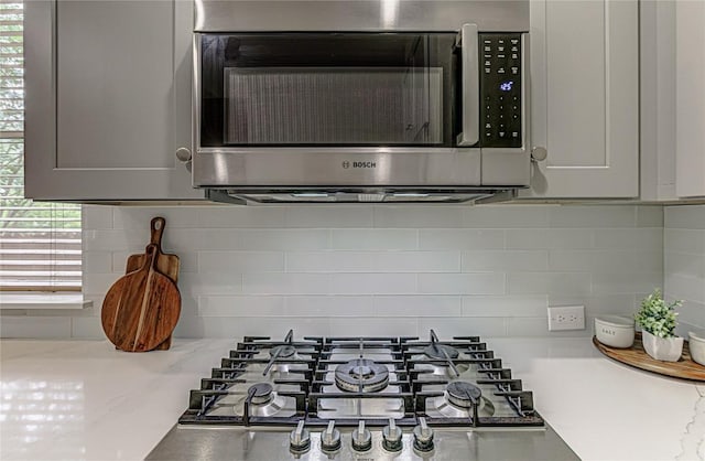 8002 Magic Mountain Cv, Round Rock, TX 78681 - kitchen view of stainless steel appliances, tasteful backsplash, and light stone counters
