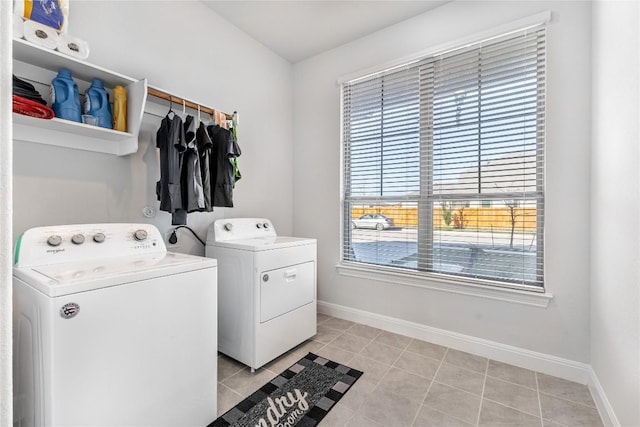 306 Pulitzer Dr, Hutto, TX 78634 - laundry room featuring washing machine and dryer, baseboards, and light tile patterned floors