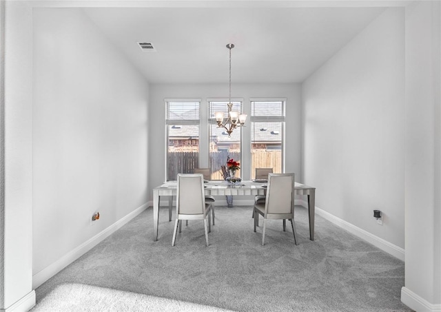 306 Pulitzer Dr, Hutto, TX 78634 - carpeted dining room featuring baseboards and a chandelier