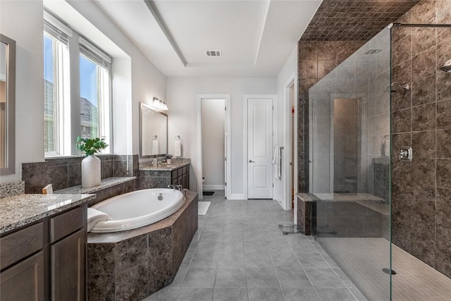 306 Pulitzer Dr, Hutto, TX 78634 - bathroom with a stall shower, a garden tub, vanity, and tile patterned floors