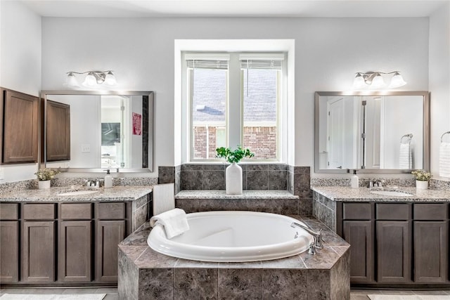 306 Pulitzer Dr, Hutto, TX 78634 - bathroom with two vanities and a bath