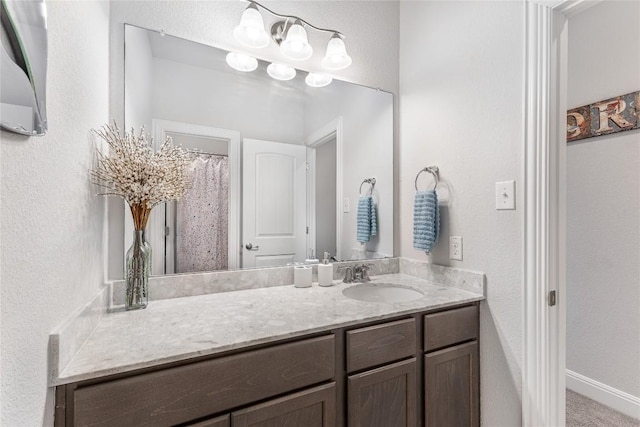 306 Pulitzer Dr, Hutto, TX 78634 - full bath featuring vanity, a textured wall, baseboards, and a shower with curtain