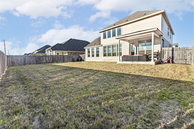 306 Pulitzer Dr, Hutto, TX 78634 - rear view of property featuring brick siding and a patio