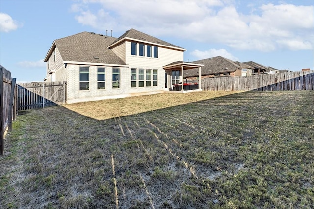 306 Pulitzer Dr, Hutto, TX 78634 - rear view of property featuring a patio area and brick siding
