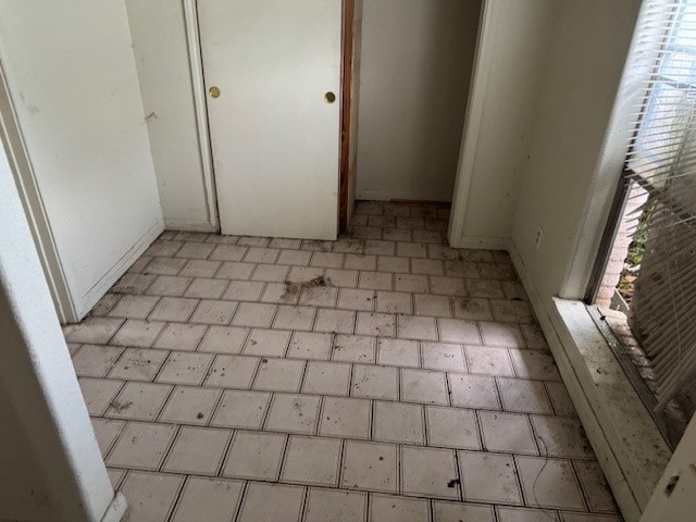 1807 Ferguson Ln, Austin, TX 78754 - empty room with baseboards and brick patterned flooring