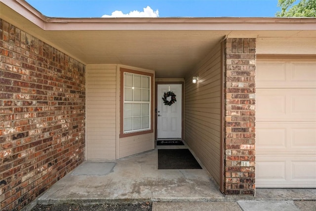 306 Southbrook Dr, Killeen, TX 76542 - view of exterior entry featuring a garage and brick siding