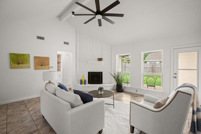 2310 Windsong Trl, Round Rock, TX 78664 - living area featuring ceiling fan, beamed ceiling, a fireplace, high vaulted ceiling, and baseboards