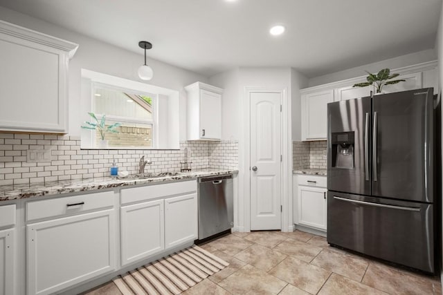 2310 Windsong Trl, Round Rock, TX 78664 - kitchen featuring stainless steel appliances, a sink, white cabinetry, decorative backsplash, and hanging light fixtures