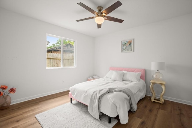 2310 Windsong Trl, Round Rock, TX 78664 - bedroom with wood finished floors, baseboards, and a ceiling fan
