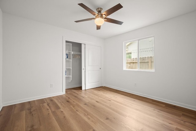 2310 Windsong Trl, Round Rock, TX 78664 - unfurnished bedroom with wood finished floors, baseboards, a closet, and ceiling fan