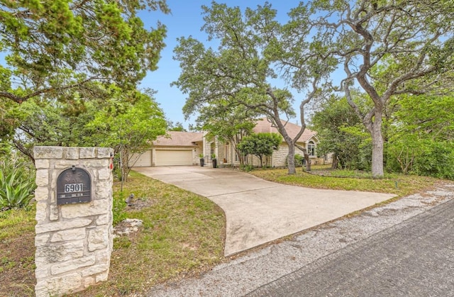 6901 W Bright Star Ln W, Austin, TX 78736 - view of front facade featuring concrete driveway and an attached garage