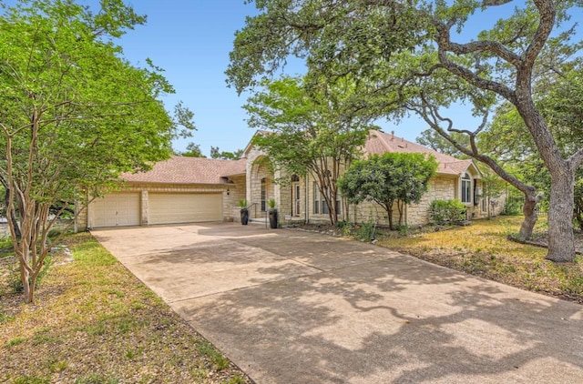 6901 W Bright Star Ln W, Austin, TX 78736 - view of front of property with concrete driveway, a garage, and stone siding