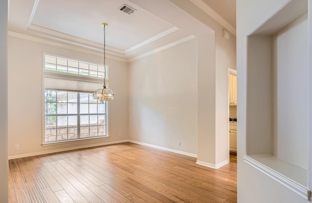 6901 W Bright Star Ln W, Austin, TX 78736 - spare room featuring a tray ceiling, light wood-style floors, a chandelier, and crown molding