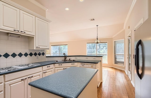 6901 W Bright Star Ln W, Austin, TX 78736 - kitchen featuring stainless steel fridge with ice dispenser, gas cooktop, dark countertops, decorative backsplash, and white cabinets