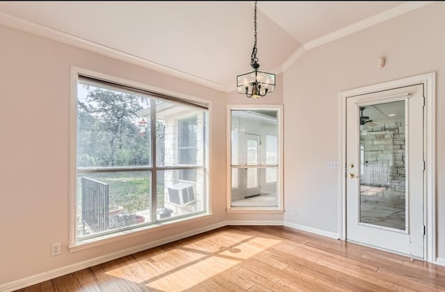 6901 W Bright Star Ln W, Austin, TX 78736 - unfurnished dining area with a chandelier, vaulted ceiling, ornamental molding, and light wood-style floors