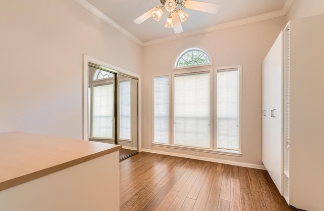 6901 W Bright Star Ln W, Austin, TX 78736 - empty room with crown molding, a ceiling fan, and hardwood / wood-style floors