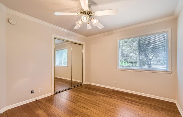 6901 W Bright Star Ln W, Austin, TX 78736 - unfurnished bedroom featuring multiple windows, hardwood / wood-style flooring, baseboards, and crown molding