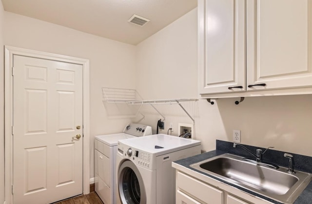 6901 W Bright Star Ln W, Austin, TX 78736 - washroom with washing machine and dryer, cabinet space, and wood finished floors
