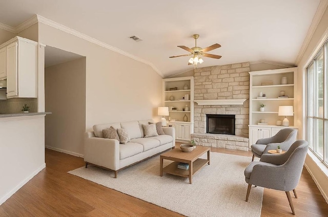 6901 W Bright Star Ln W, Austin, TX 78736 - living room featuring a ceiling fan, wood finished floors, vaulted ceiling, crown molding, and a fireplace