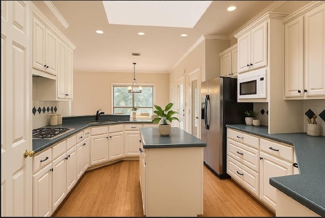 6901 W Bright Star Ln W, Austin, TX 78736 - kitchen featuring appliances with stainless steel finishes, dark countertops, crown molding, recessed lighting, and a kitchen island