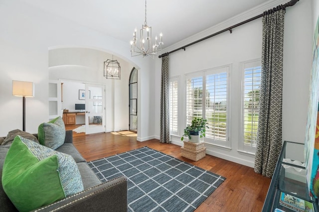 1701 Mira Vis, Leander, TX 78641 - living area featuring a chandelier, wood finished floors, and arched walkways