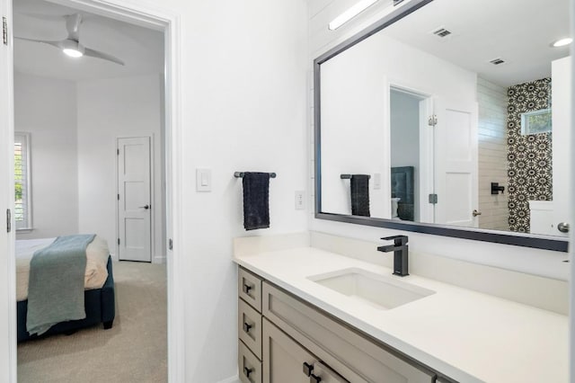 1701 Mira Vis, Leander, TX 78641 - bathroom featuring vanity, ceiling fan, connected bathroom, and a tile shower