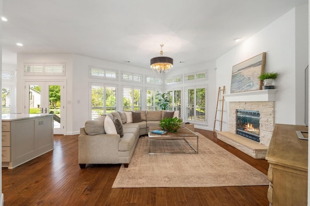 1701 Mira Vis, Leander, TX 78641 - living room featuring a chandelier, recessed lighting, dark wood-type flooring, a fireplace, and baseboards