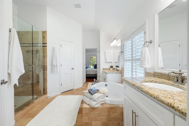 1701 Mira Vis, Leander, TX 78641 - ensuite bathroom with a stall shower, two vanities, and a garden tub