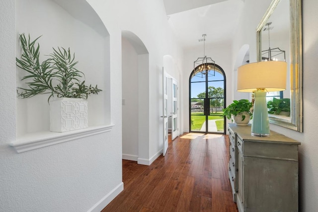 1701 Mira Vis, Leander, TX 78641 - entryway with dark wood finished floors, a chandelier, and arched walkways