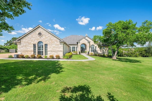 1701 Mira Vis, Leander, TX 78641 - french country home featuring stone siding and a front yard