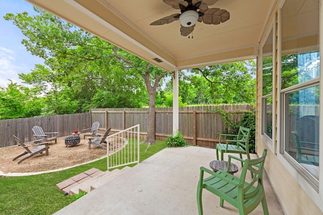 2100 Campfield Pkwy, Austin, TX 78745 - fenced backyard with an outdoor fire pit, a patio area, and a ceiling fan
