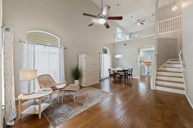 2100 Campfield Pkwy, Austin, TX 78745 - living area with arched walkways, a ceiling fan, stairway, dark wood-type flooring, and high vaulted ceiling