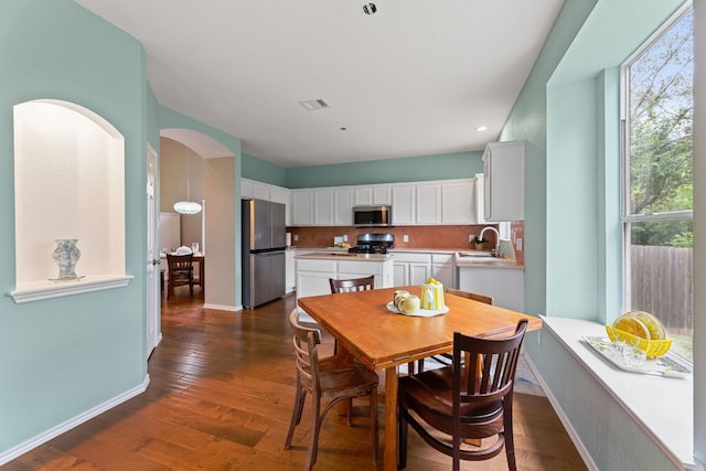 2100 Campfield Pkwy, Austin, TX 78745 - dining space with dark wood-style flooring, recessed lighting, and arched walkways