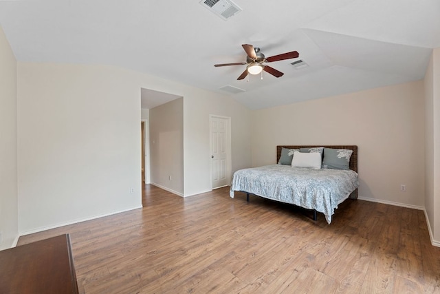 2100 Campfield Pkwy, Austin, TX 78745 - bedroom featuring wood finished floors, vaulted ceiling, a ceiling fan, and baseboards