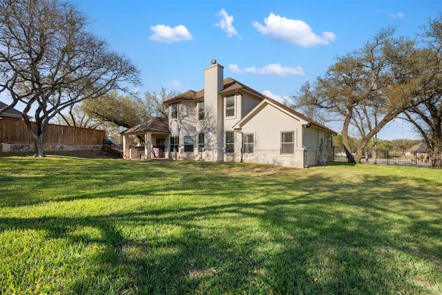 2015 Th Jones Mill Way, Salado, TX 76571 - rear view of house with a chimney, stucco siding, and stone siding