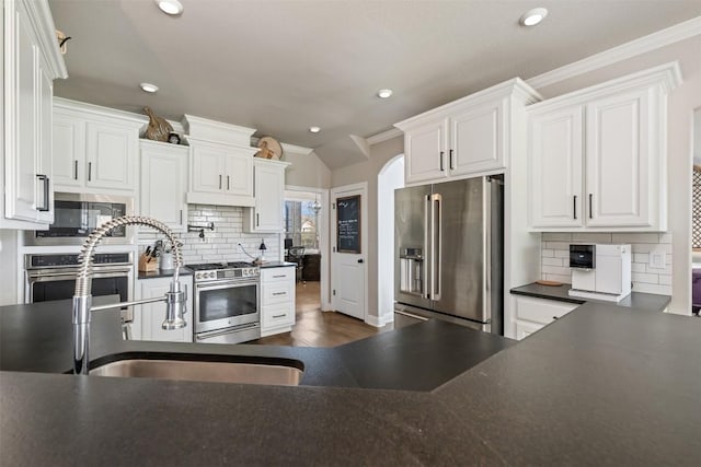 2015 Th Jones Mill Way, Salado, TX 76571 - kitchen with stainless steel appliances, dark countertops, decorative backsplash, crown molding, and recessed lighting
