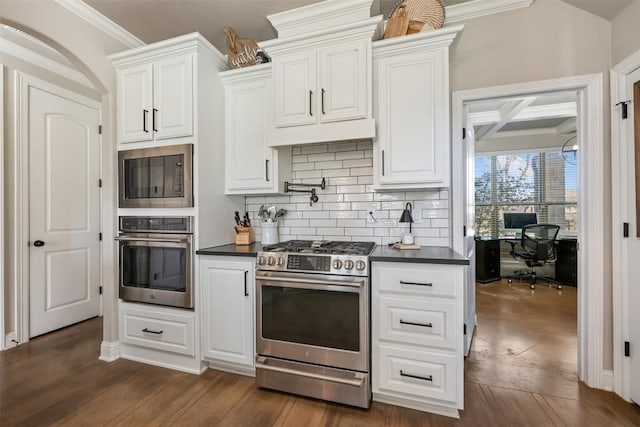 2015 Th Jones Mill Way, Salado, TX 76571 - kitchen featuring appliances with stainless steel finishes, dark countertops, white cabinets, backsplash, and ornamental molding